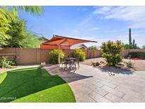 Spacious backyard with patio, artificial turf, and shade structure at 4601 E Peak View Rd, Cave Creek, AZ 85331