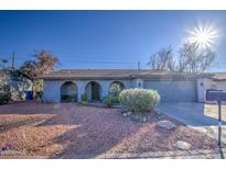 Ranch-style home with a two-car garage and landscaped front yard at 6355 W Caron St, Glendale, AZ 85302