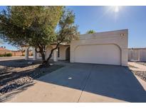 Single-story home with a two-car garage and a well-maintained front yard at 7101 W Laurel Ln, Peoria, AZ 85345