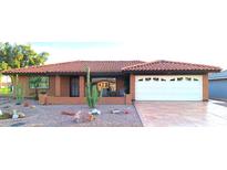 Single-story home with terracotta tile roof and desert landscaping at 7813 E Lakeview Ave, Mesa, AZ 85209