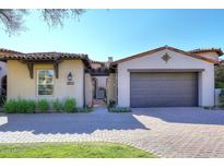 Spanish style home with attached garage and gated entry at 8911 E Rusty Spur Pl, Scottsdale, AZ 85255