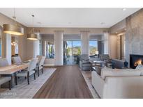 Open floor plan with hardwood floors, a fireplace, and a dining table at 9740 E Lofty Point Rd, Scottsdale, AZ 85262