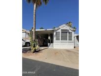 White single-wide manufactured home with covered carport and desert landscaping at 1448 S Zuni --, Apache Junction, AZ 85119