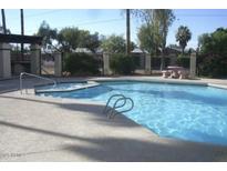 Community pool with a spa and surrounding patio at 2121 W Union Hills Dr # 115, Phoenix, AZ 85027