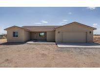 New single-story home with attached two-car garage and desert landscaping at 24604 W Duane Ln, Wittmann, AZ 85361