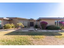 Well-maintained mid-century modern home with attractive landscaping at 10814 W Thunderbird Blvd, Sun City, AZ 85351