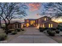 Elegant two-story home with a brick driveway and landscaped grounds at 10855 E Elba Way, Scottsdale, AZ 85262