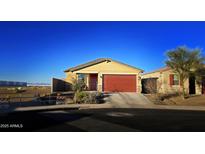 House exterior featuring a red garage door and light yellow walls at 12668 W Orangewood Ave, Glendale, AZ 85307