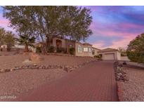 Brick paved pathway leads to a charming house with desert landscaping at 15859 N Nyack Dr, Fountain Hills, AZ 85268