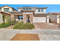 Two-story home with stone accents and a two-car garage at 21002 E Mayberry Rd, Queen Creek, AZ 85142