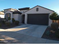 Single-story home with two-car garage and desert landscaping at 26035 W Quail Ave, Buckeye, AZ 85396