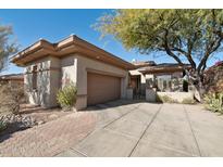 Single-story home with a two-car garage and landscaped front yard at 30994 N 74Th Way, Scottsdale, AZ 85266