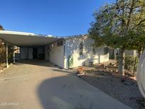 Mobile home with carport and landscaped yard at 3721 N Illinois Ave, Florence, AZ 85132