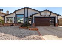 Updated home exterior boasts a modern garage door and attractive landscaping at 4009 W Cielo Grande Rd, Glendale, AZ 85310