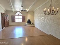 Spacious living room with hardwood floors, stylish lighting fixture and a unique fireplace at 5100 N Miller Rd # 20, Scottsdale, AZ 85250