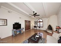 Living room featuring hardwood floors, fireplace and high ceilings at 5100 N Miller Rd # 20, Scottsdale, AZ 85250