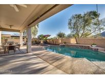 Covered patio with outdoor dining and pool view at 5227 W Desperado Way, Phoenix, AZ 85083