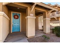 Inviting teal front door with a festive wreath, welcoming you to this charming home at 5856 E Hampton Ave, Mesa, AZ 85206