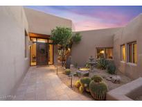 Desert landscape entry with tile walkway leading to a wood front door at 10758 E Tamarisk Way, Scottsdale, AZ 85262