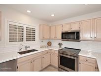 Kitchen with stainless steel appliances and white cabinets at 15050 N Thompson Peak Pkwy # 1010, Scottsdale, AZ 85260