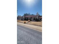 Single-story home with desert landscaping and a long driveway at 15829 N 12Th St, Phoenix, AZ 85022