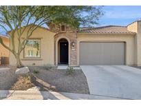 Single-story home with a two-car garage and desert landscaping at 16955 W Holly St, Goodyear, AZ 85395