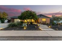 Brick home with landscaped yard, updated garage, and walkway lighting at 1837 E Minnezona Ave, Phoenix, AZ 85016