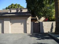 Tan stucco condo building with a two-car garage and gated entry at 2208 W Lindner Ave # 17, Mesa, AZ 85202