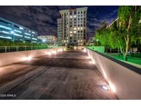 Night view of modern building, with well-lit walkway at 2211 E Camelback Rd # 201, Phoenix, AZ 85016