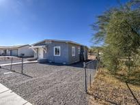 Gray stucco house exterior with chain link fence and gravel yard at 232 S San Carlos St, Florence, AZ 85132