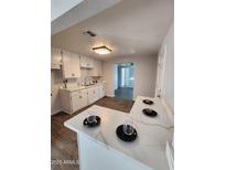 Renovated kitchen with white cabinets and quartz countertops at 2523 N 28Th St, Phoenix, AZ 85008