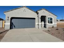 New single-story home with a two-car garage and neutral color scheme at 25512 N 183Rd Ln, Wittmann, AZ 85361