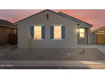 New home exterior boasts a neutral color palette, blue shutters, and a landscaped front yard at 2669 E Santa Ynez Dr, Casa Grande, AZ 85194