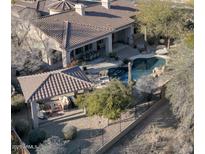 Backyard oasis with a sparkling pool, covered patio, and lush landscaping at 32029 N 19Th Ln, Phoenix, AZ 85085