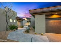 Stylish home features desert landscaping, a paved walkway, and a modern architectural design at 39493 N 107Th Way, Scottsdale, AZ 85262