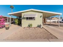 Mobile home with carport and landscaped area at 6960 W Peoria Ave # 171, Peoria, AZ 85345