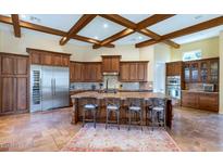 Gourmet kitchen with island, stainless steel appliances, and wood beams at 7575 E Camino Salida Del Sol --, Scottsdale, AZ 85266