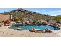 Inviting freeform pool with a natural rock border and desert landscaping at 7575 E Camino Salida Del Sol --, Scottsdale, AZ 85266