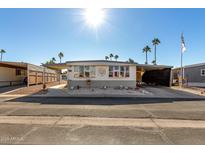 Single-wide manufactured home with carport and small front yard at 9501 E Broadway Rd # 178, Mesa, AZ 85208