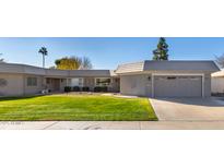 Single story home with attached garage and well-manicured lawn at 10161 W Pineaire Dr, Sun City, AZ 85351