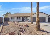 Updated single-story home with a landscaped front yard and two-car garage at 1104 N Oak Ct, Gilbert, AZ 85233