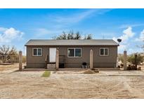 Single story home with desert landscaping and spacious yard at 13705 S 209Th Ave, Buckeye, AZ 85326