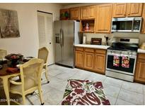 Kitchen with wood cabinets, stainless steel appliances at 14300 W Bell Rd # 5, Surprise, AZ 85374