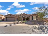 Single-story home with desert landscaping and a three-car garage at 2223 W Hazelhurst Ct, Anthem, AZ 85086