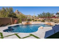 Luxury pool with a waterfall feature and mountain views at 25838 N 104Th Pl, Scottsdale, AZ 85255