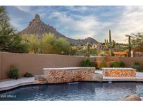 Inviting pool area with desert landscape views and waterfall feature at 25838 N 104Th Pl, Scottsdale, AZ 85255