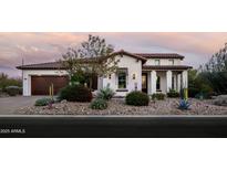 Inviting single-story home showcasing desert landscaping, a tile roof, and an attached two-car garage at 29615 N 55Th Pl, Cave Creek, AZ 85331