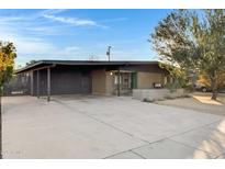 Mid-century modern home with carport and landscaped front yard at 3645 E Shaw Butte Dr, Phoenix, AZ 85028