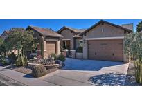 Single-story home with desert landscaping and two-car garage at 3649 N Hudson Dr, Florence, AZ 85132