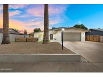 Charming single-story home featuring a well-maintained front yard, attached garage, and inviting curb appeal at 3929 E Mercer Ln, Phoenix, AZ 85028